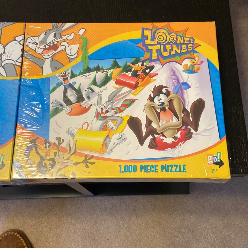 2 puzzles.  Looney Toons.  1000 pieces each.   One new and one built once